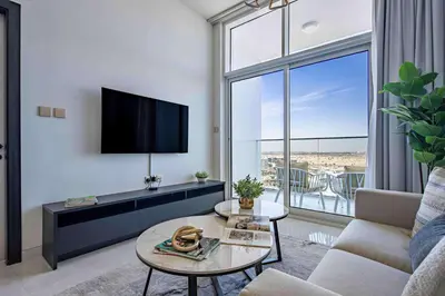 a living room with a tv and a couch at Frank Porter - Skyz By Danube in Dubai