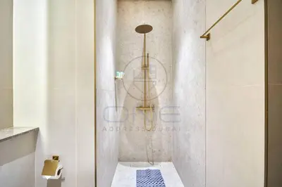 a shower with a glass door in a bathroom at Binghatti Royale premium 1BR with Jacuzzi in Dubai