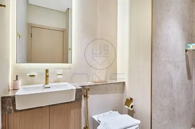 a bathroom with a sink and a toilet at Binghatti Royale premium 1BR with Jacuzzi in Dubai