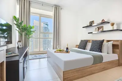 a bedroom with a large bed and a large window at Frank Porter - Goldcrest Executive in Dubai