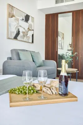 a table with two glasses and a bottle of wine at Frank Porter - Goldcrest Executive in Dubai