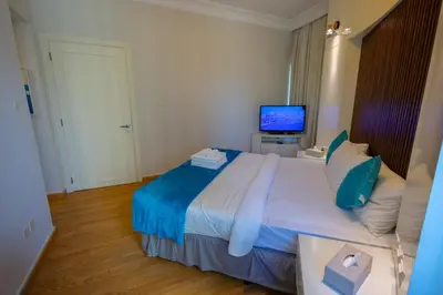 a bedroom with a large bed and a television at Damac Downtown 1 BHK apartment with Burj Khalifa view in Dubai