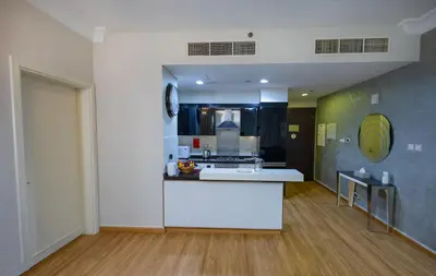 a kitchen with a white counter in a room at Damac Downtown 1 BHK apartment with Burj Khalifa view in Dubai