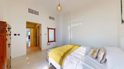 a bedroom with a bed with a yellow blanket on it at Luxury 2br Penthouse Spacious in Dubai