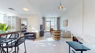 a living room with a table and chairs and a living room at Luxury 2br Penthouse Spacious in Dubai