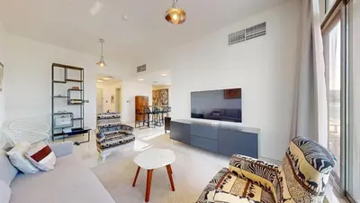 a living room with a couch and a tv at Luxury 2br Penthouse Spacious in Dubai