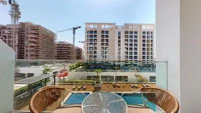 a balcony with a table and chairs and a building at Luxurious Chic Comfort Studio in Dubai