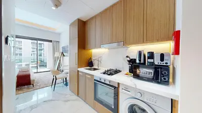 a kitchen with a washer and dryer at Luxurious Chic Comfort Studio in Dubai