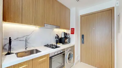 a small kitchen with a sink and a stove at Luxurious Chic Comfort Studio in Dubai