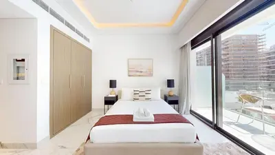 a bedroom with a large bed and a large window at Luxurious Chic Comfort Studio in Dubai