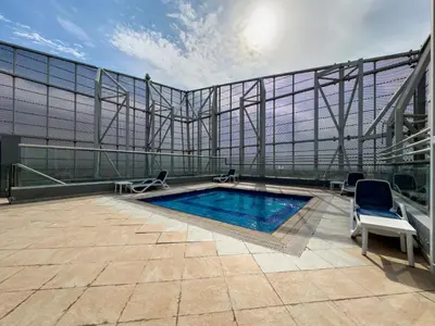 a swimming pool on the roof of a building at Settler Homes - Premium Matrix Tower with Hot Tub in Dubai