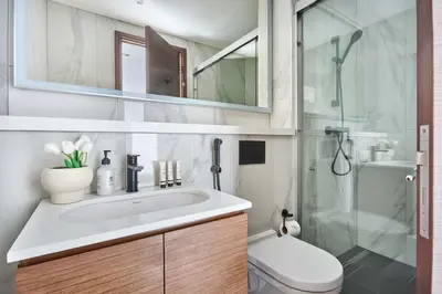 a bathroom with a sink and a shower at Frank Porter - The Crest Tower, Sobha Hartland in Dubai