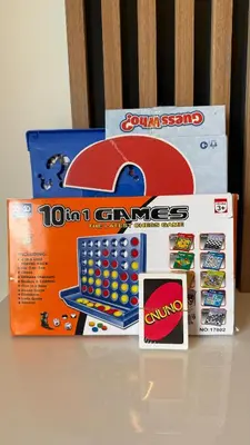 two boxes of dominoes and a game on a table at Lux 2 Bedroom Cozy Family Getaway Home in Dubai