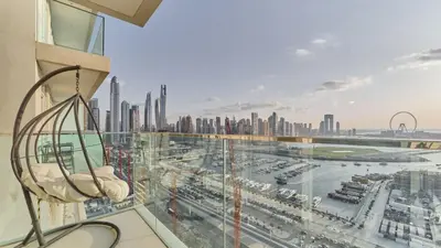 a balcony with a view of a city at Prime 3BR Maid Sunrise Bay Ain Dubai Palm View in Dubai