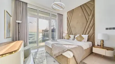 a bedroom with a bed and a large window at Prime 3BR Maid Sunrise Bay Ain Dubai Palm View in Dubai