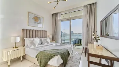 a bedroom with a bed and a large window at Prime 3BR Maid Sunrise Bay Ain Dubai Palm View in Dubai