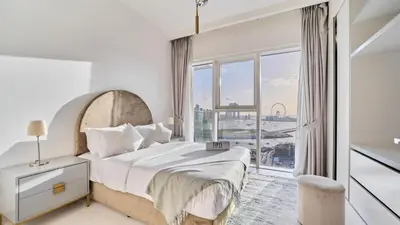 a bedroom with a large bed and a large window at Prime 3BR Maid Sunrise Bay Ain Dubai Palm View in Dubai