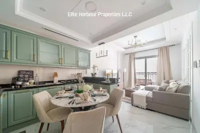 a kitchen with green cabinets and a table and chairs at Luxury Apartment in Vincitore Benessere, Dubai in Dubai