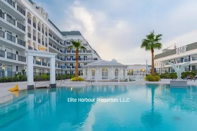 a large swimming pool in front of a building at Luxury Apartment in Vincitore Benessere, Dubai in Dubai