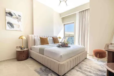 a bedroom with a large bed and a large window at Frank Porter - Avenue Residence in Dubai
