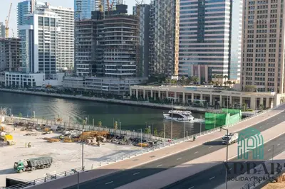 a city with a river and a bridge and buildings at Arbab Homes Luxury 1BR - Canal View - Damac Zada Tower in Dubai
