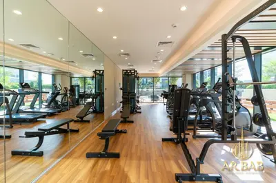 a gym with treadmills and elliptical machines at Arbab Homes Luxury 1BR - Canal View - Damac Zada Tower in Dubai