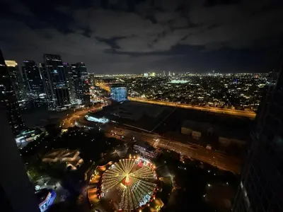 a view of a city at night with a ferris wheel at Modern 1-BR in Armada Tower 3, JLT, Sky Views in Dubai