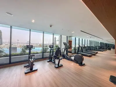 a gym with treadmills and ellipticals in a building at Modern Studio with Private Jacuzzi in Dubai
