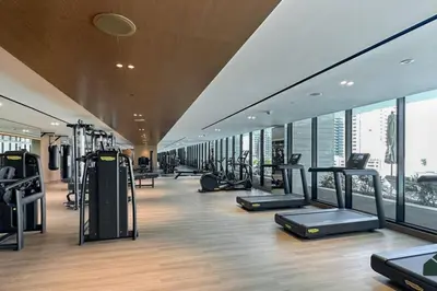 a gym with treadmills and ellipticals in a building at Modern Studio with Private Jacuzzi in Dubai