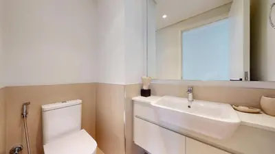 a bathroom with a sink and a toilet and a mirror at Vacationer l Upgraded Aesthetic 2 Bed l near Dubai Hills Mall in Dubai