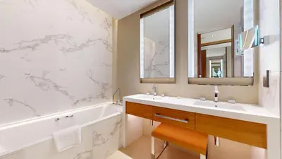 a bathroom with a sink and a tub and a mirror at Vacationer l Elegant 2 Bed l near Burj Khalifa l Address Opera in Dubai