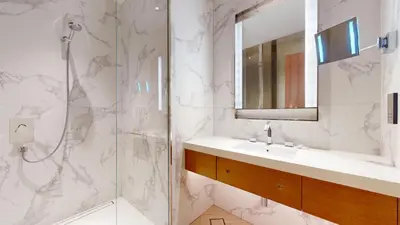 a bathroom with a shower and a sink and a mirror at Vacationer l Elegant 2 Bed l near Burj Khalifa l Address Opera in Dubai