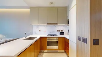 a kitchen with a sink and a stove at Vacationer l Elegant 2 Bed l near Burj Khalifa l Address Opera in Dubai