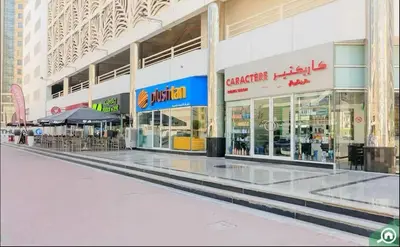 an empty shopping mall with tables and chairs in it at Modren Private Partition Room In Barsha Heights Tecom in Dubai