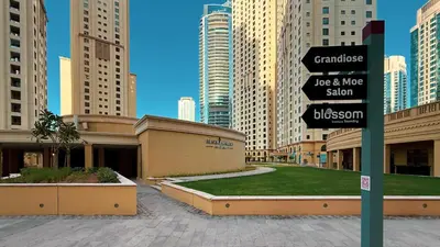 a street sign in a city with tall buildings at Luxe 4BR Upscale Beach Side Unit with Pool Table in Dubai