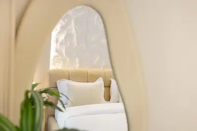 a mirror in a room with a couch and a window at Lux condo 3 BHK in Dubai Marina in Dubai