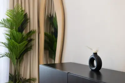 a black vase sitting on top of a black cabinet at Lux condo 3 BHK in Dubai Marina in Dubai