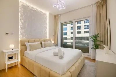 a bedroom with a large white bed and a window at Lux condo 3 BHK in Dubai Marina in Dubai