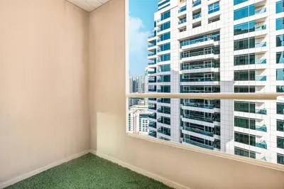 an empty room with a window with a view of a tall building at Luxury 3BHK with floating bed in Marina in Dubai
