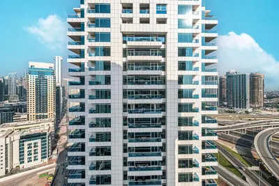 a tall white building with many windows in a city at Luxury 3BHK with floating bed in Marina in Dubai