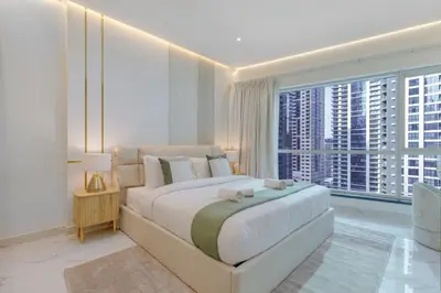 a white bedroom with a large bed and a large window at Elegant 2-Bedroom Apartment in Marina Heights 1, Dubai Marina in Dubai