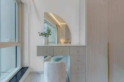 a bathroom with a mirror and a chair at Elegant 2-Bedroom Apartment in Marina Heights 1, Dubai Marina in Dubai