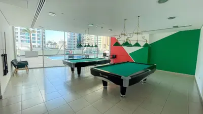 a room with two pool tables in a room with a pool table at Elegant 2-Bedroom Apartment in Marina Heights 1, Dubai Marina in Dubai