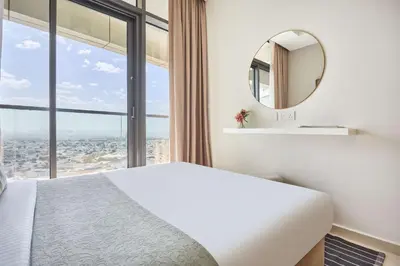 a bedroom with a bed and a mirror at Frank Porter - Aykon City, Business Bay in Dubai