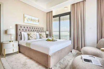 a bedroom with a large bed with a large window at Frank Porter - Aykon City, Business Bay in Dubai