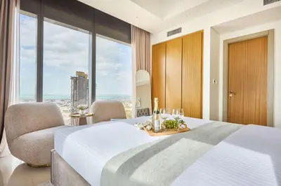 a bedroom with a large bed and a large window at Frank Porter - Aykon City, Business Bay in Dubai