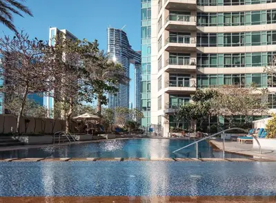 a swimming pool in a city with tall buildings at Frank Porter - Loft Tower West in Dubai