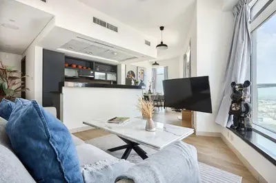 a living room with a couch and a table at Frank Porter - Loft Tower West in Dubai