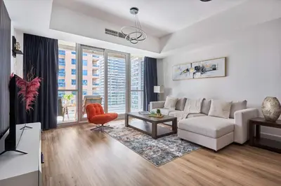 a living room with a couch and a chair at Frank Porter - Damac Waves Tower, Dubai Marina in Dubai