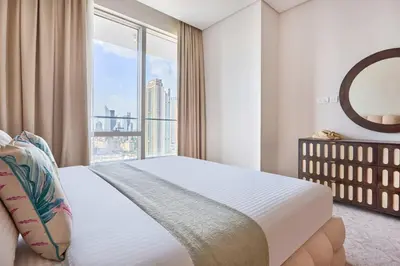 a bedroom with a bed and a large window at Frank Porter - Vida Dubai Mall in Dubai